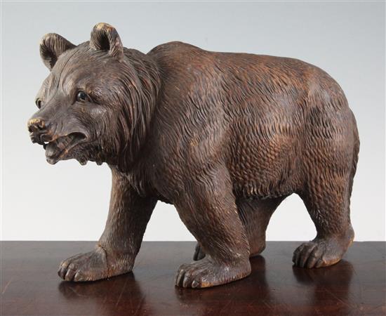 An early 20th century Black Forest carved wood bear, length 12in.